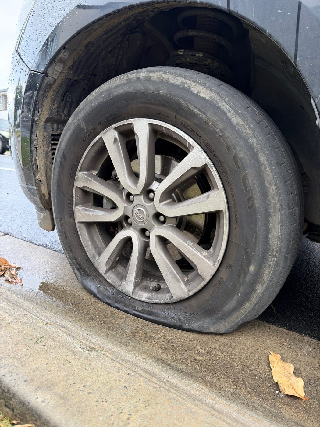Worn, punctured tyre on a Nissan Pathfinder before replacement in Catherine Field