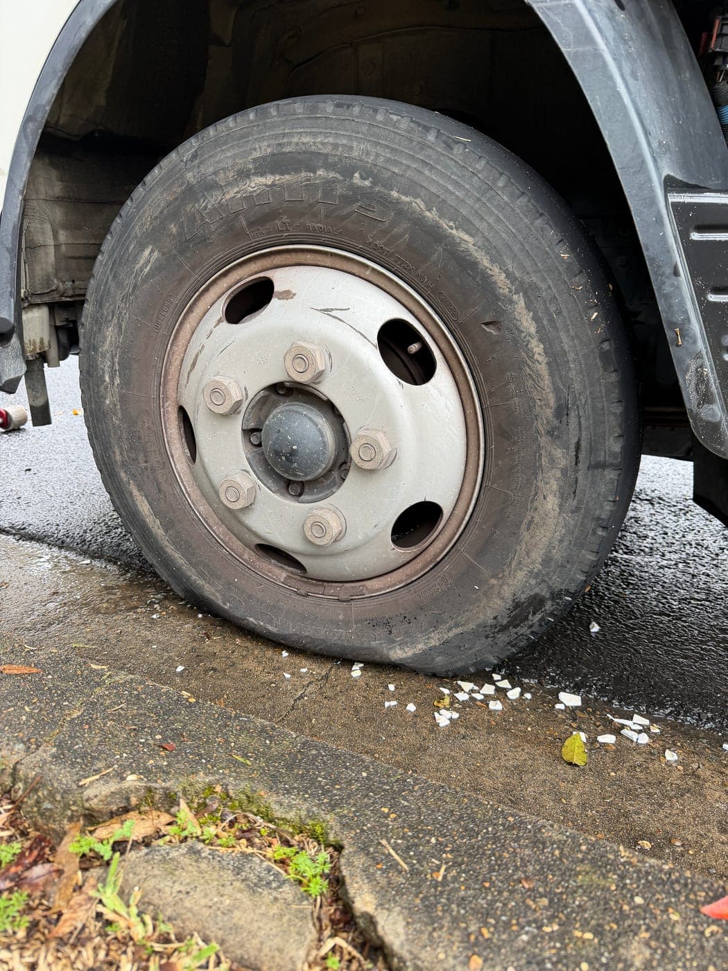 Worn, flat Isuzu truck tyre before replacement in Chester Hill
